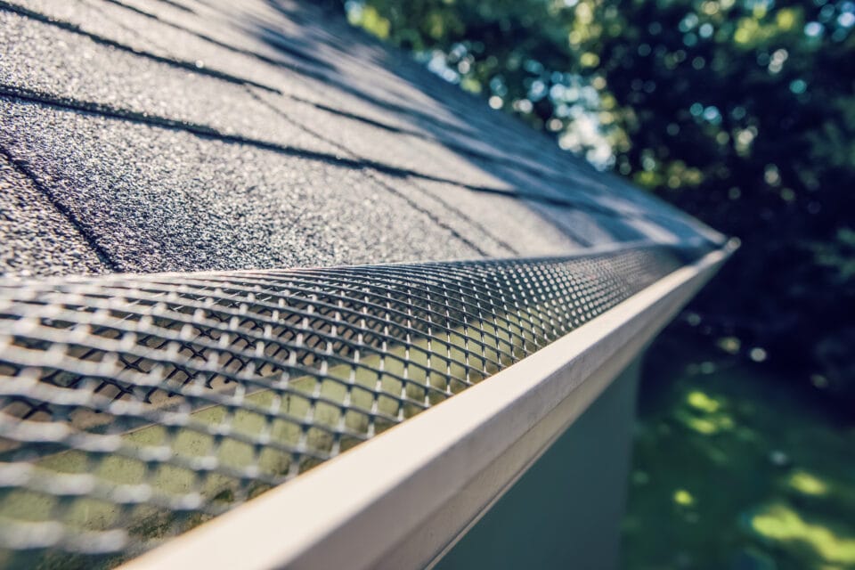 plastic,guard,over,gutter,trough,on,a,roof