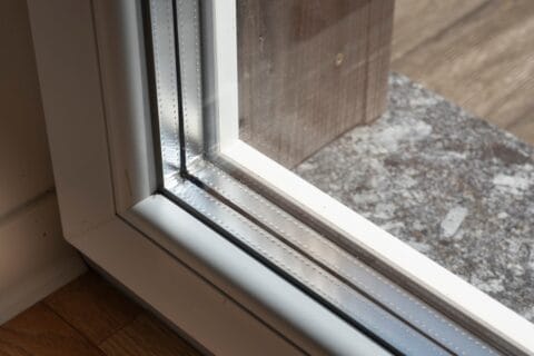 detail,of,a,window,frame,with,triple,glazing.,the,space