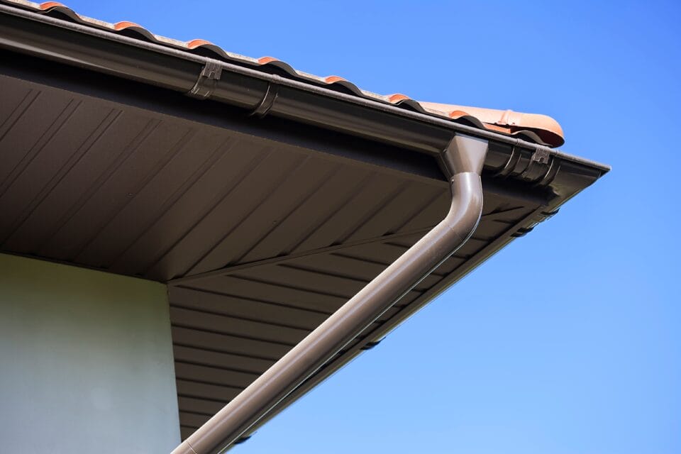 house,with,new,brown,metal,tile,roof,and,rain,gutter.