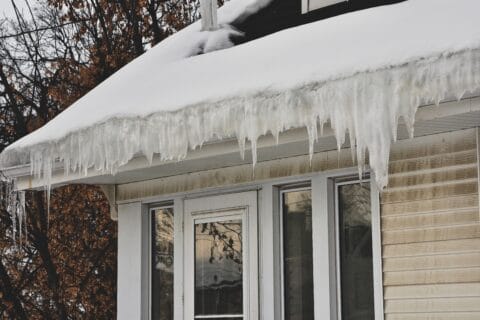 melting,snow,on,roof,creating,ice,dam,in,gutter,with