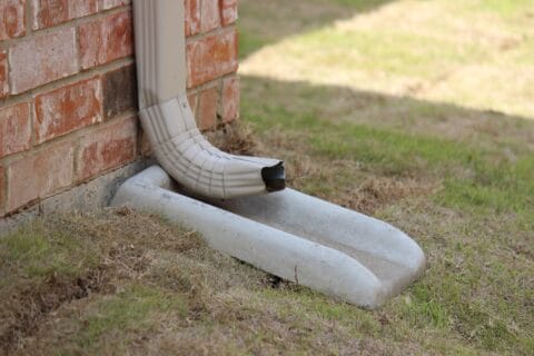 downspout,emptying,rain,water,into,a,splash,block,,concrete,splash